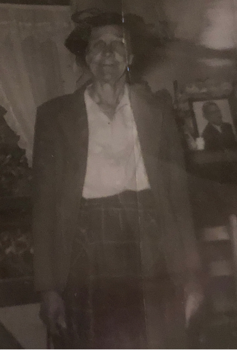 Elderly woman in a hat and jacket